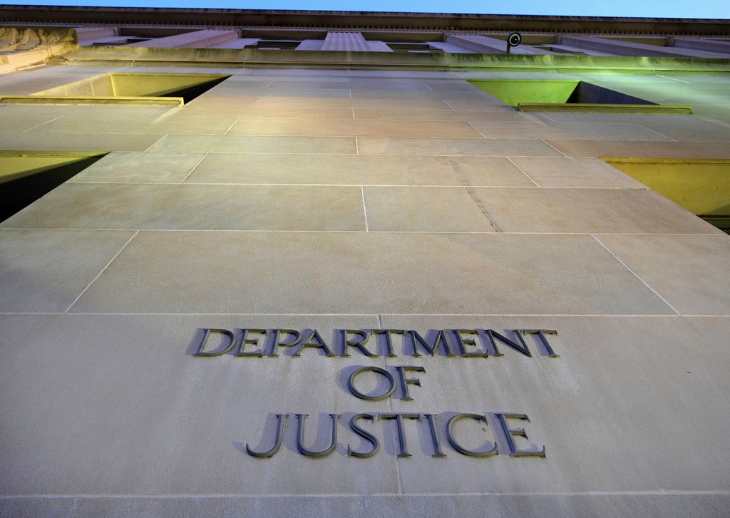 FILE - Tthe Department of Justice headquarters building in Washington is photographed early in the morning, May 14, 2013. (AP Photo/J. David Ake, File)