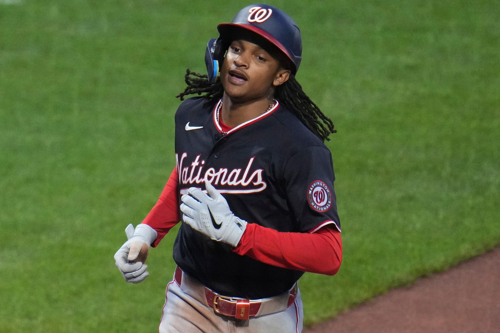 Washington Nationals' CJ Abrams crosses home plate after hitting a solo home run off Pittsburgh Pirates pitcher Mitch Keller during the third inning of a baseball game in Pittsburgh, Tuesday, April 14, 2026. (AP Photo/Gene J. Puskar)