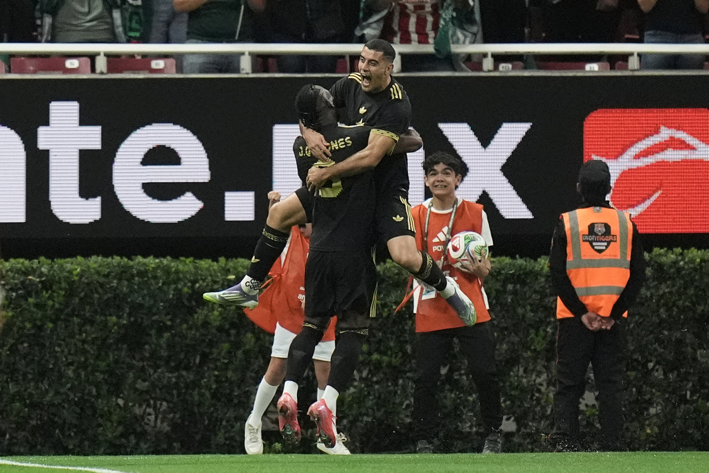 Mexico's Germán Berterame, top, is congratulated after scoring his side's opening goal against Ecuador during a friendly soccer match at Akron stadium in Guadalajara, Mexico, Tuesday, Oct. 14, 2025. (AP Photo/Eduardo Verdugo)