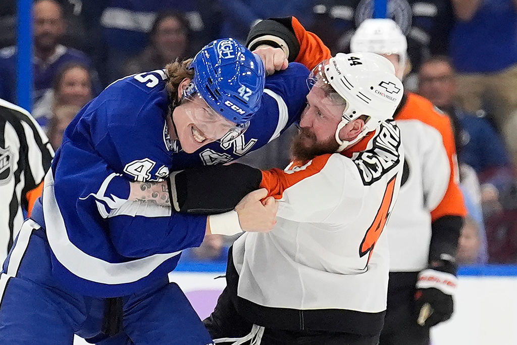 Tampa Bay Lightning center Curtis Douglas (42) and Philadelphia Flyers left wing Nicolas Deslauriers (44) fight during the first period of an NHL hockey game Monday, Nov. 24, 2025, in Tampa, Fla. (AP Photo/Chris O'Meara)