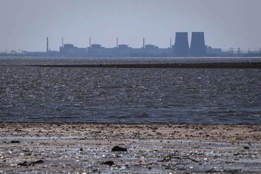 FILE - The Zaporizhzhia nuclear power plant, Europe's largest, stands in the background of the shallow Kakhovka Reservoir after the dam collapse, in Energodar, Russian-occupied Ukraine, June 9, 2023. (AP Photo/Kateryna Klochko, File) FILE - The Zaporizhzhia nuclear power plant, Europe's largest, stands in the background of the shallow Kakhovka Reservoir after the dam collapse, in Energodar, Russian-occupied Ukraine, June 9, 2023. (AP Photo/Kateryna Klochko, File)