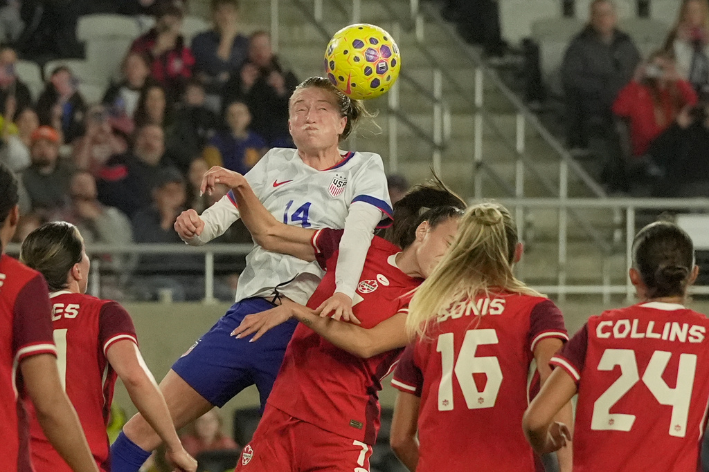 United States' Emily Sonnett (14) heads the ball next to Canada's Julia Grosso (7) in the first half of a SheBelieves Cup women's soccer match in Columbus, Ohio, Wednesday, March 4, 2026. (AP Photo/Sue Ogrocki)