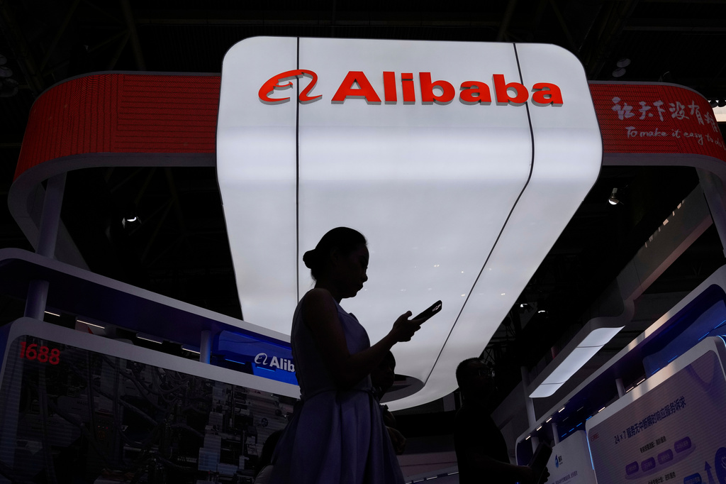 FILE - A visitor walks in front of Alibaba booth during the 3rd China International Supply Chain Expo at the China International Exhibition Center, in Beijing, China, Friday, July 18, 2025. (AP Photo/Mahesh Kumar A., file)