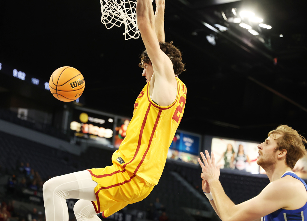 Iowa State forward Blake Buchanan (23) dunks the ball near Creighton forward Isaac Traudt (41) during the first half of an NCAA college basketball game Tuesday, Nov. 25, 2025, in Las Vegas. (AP Photo/Ronda Churchill)