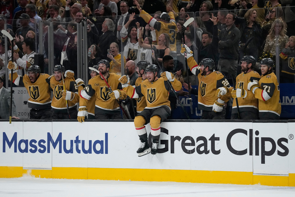Vegas Golden Knights players celebrate at the end of Game 4 of the Western Conference finals NHL hockey Stanley Cup playoff series against the Colorado Avalanche Tuesday, May 26, 2026, in Las Vegas. (AP Photo/John Locher)