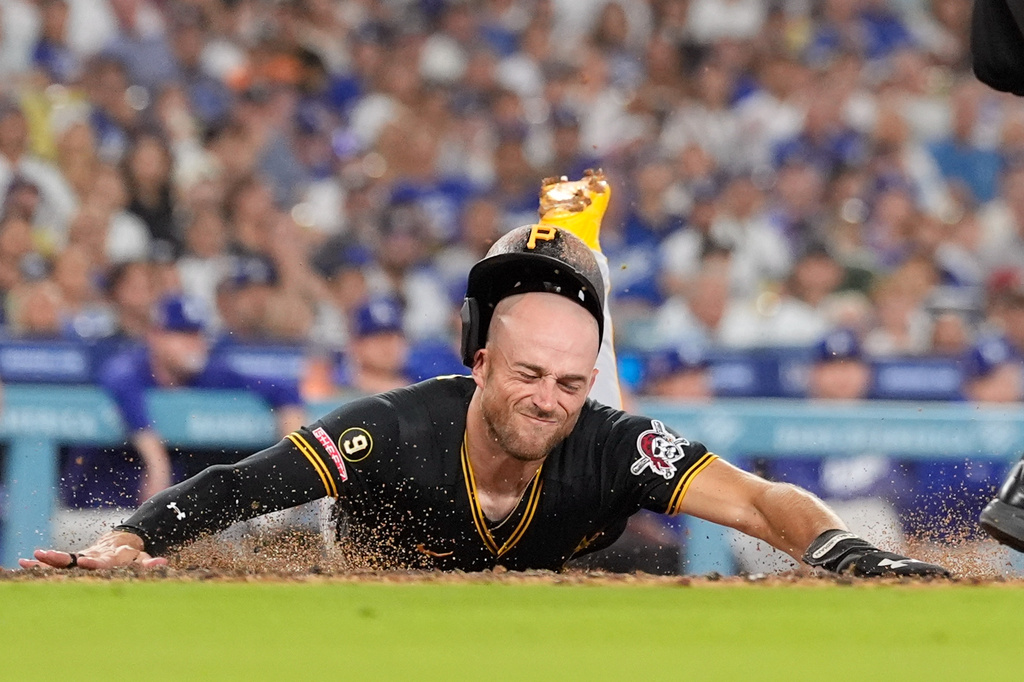 Pittsburgh Pirates' Brandon Lowe scores on a single by Nick Gonzales during the third inning of a baseball game against the Los Angeles Dodgers, Friday, Aug. 21, 2026, in Los Angeles. (AP Photo/Mark J. Terrill)