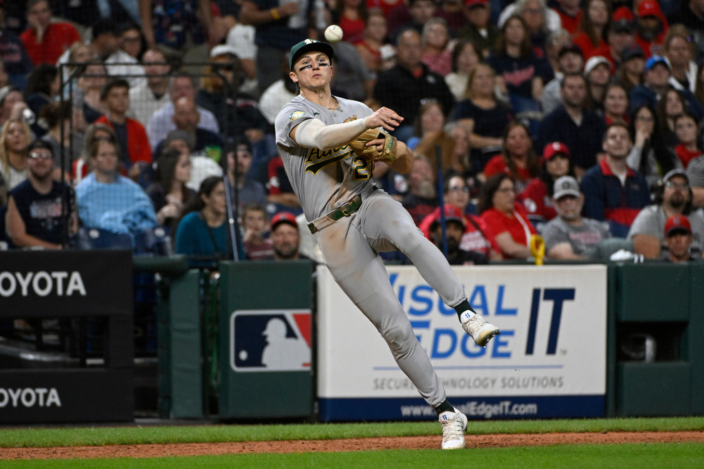 Athletics' Zack Gelof throws out Cleveland Guardians' Jo Adell at first base during the sixth inning of a baseball game, Saturday, Sept. 19, 2026, in Cleveland. (AP Photo/Phil Long)