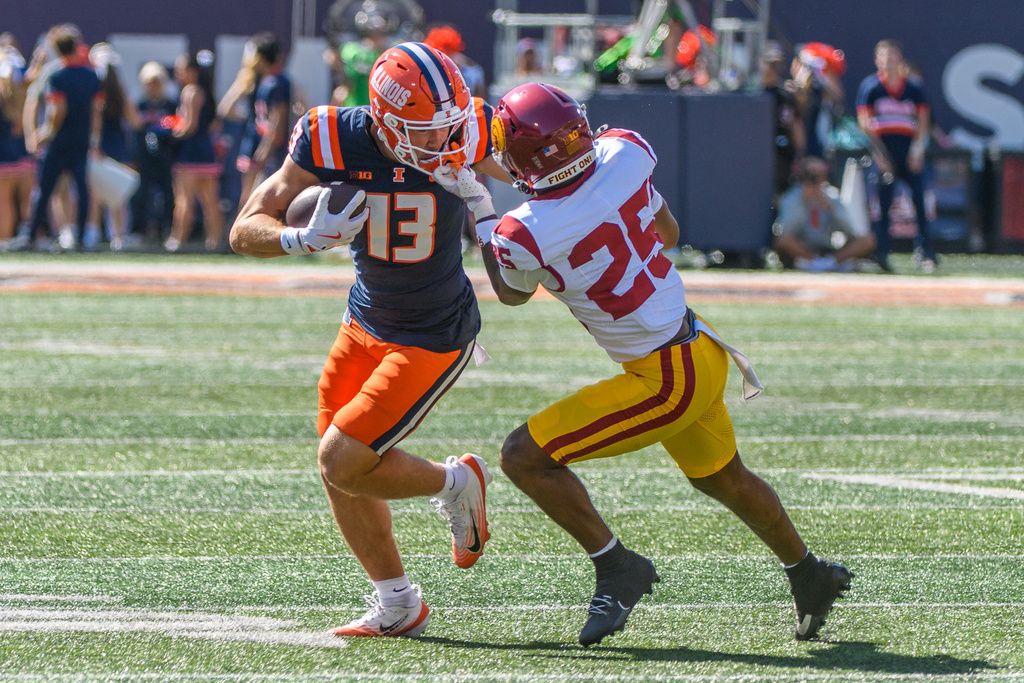 Southern California cornerback Marcelles Williams (25) grabs the face mask of Illinois wide receiver Hudson Clement (13) during the first half of an NCAA college football game, Saturday, Sept. 27, 2025, in Champaign, Ill. (AP Photo/Craig Pessman)