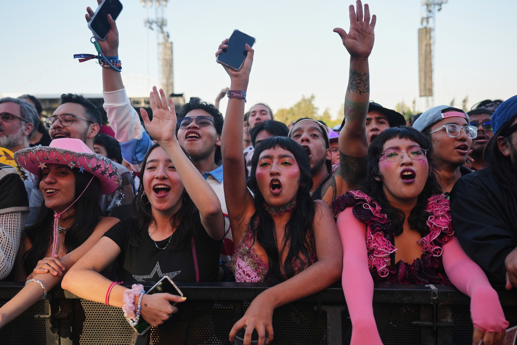 Fans of U.S. band Haute & Freddy, watch their performance during the Corona Capital music festival in Mexico City, Saturday, Nov. 15, 2025. (AP Photo/Claudia Rosel)