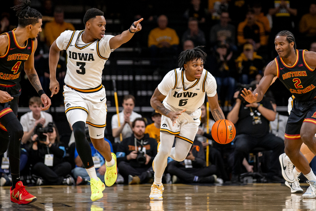 Iowa forward Cam Manyawu (3) points as guard Tavion Banks (6) dribbles during an NCAA college basketball game against USC, Wednesday, Jan. 28, 2026. (Nick Rohlman/The Gazette via AP)