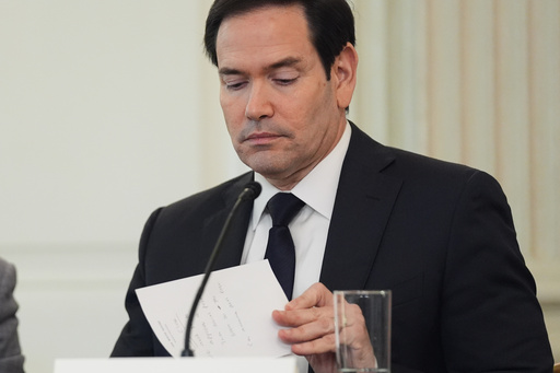 Secretary of State Marco Rubio writes a note before handing it to President Donald Trump during a roundtable meeting on antifa in the State Dining Room at the White House, Wednesday, Oct. 8, 2025, in Washington. (AP Photo/Evan Vucci) Secretary of State Marco Rubio writes a note before handing it to President Donald Trump during a roundtable meeting on antifa in the State Dining Room at the White House, Wednesday, Oct. 8, 2025, in Washington. (AP Photo/Evan Vucci)