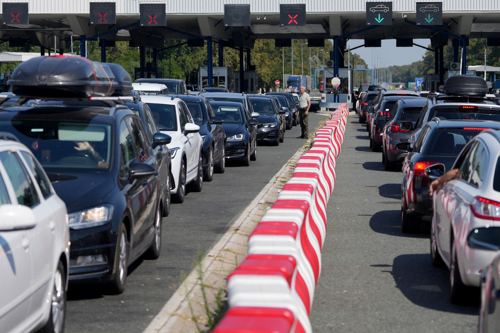 Motorists wait to cross the Croatian border from Serbia, at Batrovci border crossing, Serbia, Friday, July 31, 2026. (AP Photo/Darko Vojinovic)