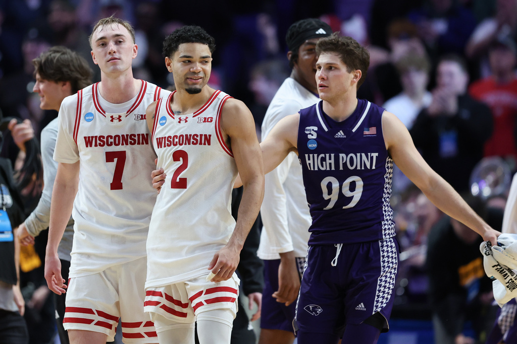 Wisconsin guard Nick Boyd (2) and guard Andrew Rohde (7) react with High Point guard Chase Johnston (99) after the first round of the NCAA college basketball tournament Thursday, March 19, 2026, in Portland, Ore. (AP Photo/Amanda Loman)