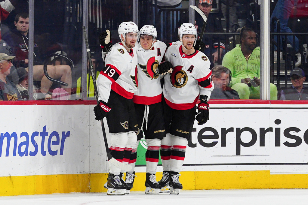 Ottawa Senators' Tim Stützle, center, celebrates his game wining goal with Drake Batherson (19) and Thomas Chabot (72) during overtime in an NHL hockey game against the Philadelphia Flyers, Saturday, Nov. 8, 2025, in Philadelphia. (AP Photo/Derik Hamilton)