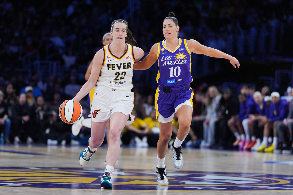 Los Angeles Sparks guard Kelsey Plum (10) pressures Indiana Fever guard Caitlin Clark (22) during the first half of a WNBA basketball game Wednesday, May 13, 2026, in Los Angeles. (AP Photo/Jae C. Hong)
