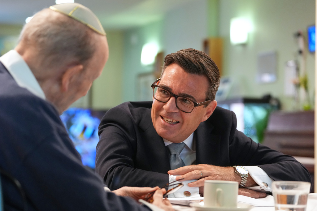 Britain's Prime Minister Andy Burnham speaks to a resident as he visits a care home in London, Wednesday, July 29, 2026.(AP Photo/Kirsty Wigglesworth, Pool)