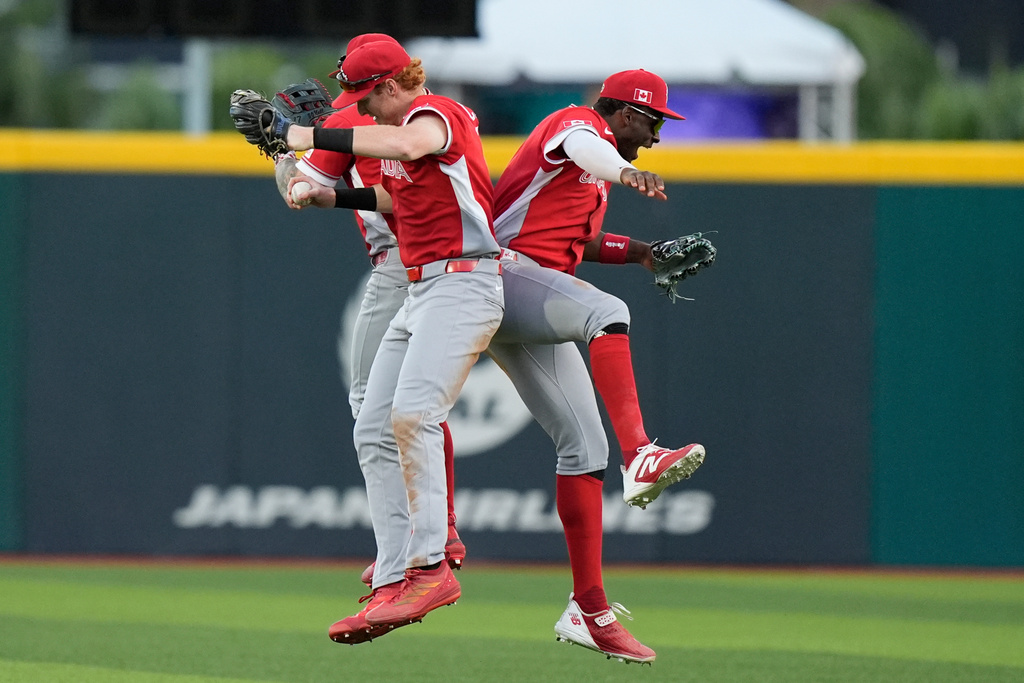 Canadian players celebrate at the end of a World Baseball Classic game Cuba in San Juan, Puerto Rico, Wednesday, March 11, 2026. (AP Photo/Fernando Llano)