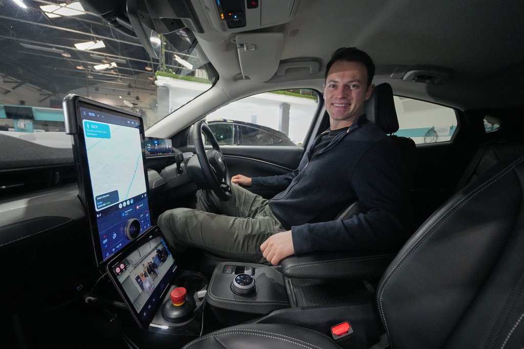 Britain Robotaxis Alex Kendall, co-founder and CEO of Wayve, sits in the autonomous vehicle during an interview in London, Monday, Feb. 9, 2026. (AP Photo/Kin Cheung)