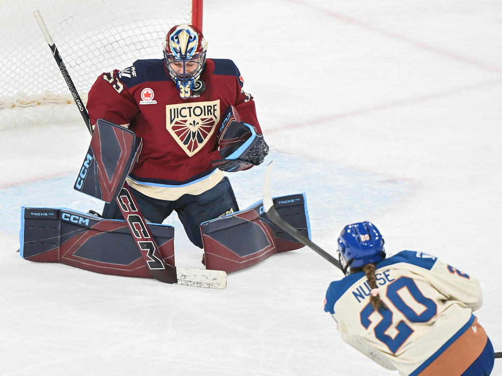 Vancouver Goldeneyes' Sarah Nurse (20) takes a shot on Montreal Victoire goaltender Ann-Renee Desbiens (35) during second period PWHL hockey game in Laval, Que., Wednesday, April 1, 2026. (Graham Hughes/The Canadian Press via AP)