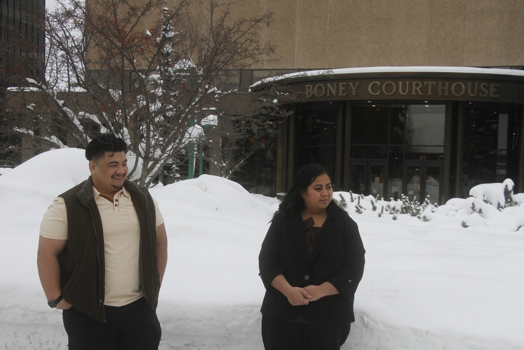 Michael Pese and his wife, Tupe Smith, stand outside the Boney Courthouse in Anchorage, Alaska, Thursday, Jan. 15, 2026, ahead of the Alaska Court of Appeals hearing a challenge to the voter fraud case brought against her by the state. (AP Photo/Mark Thiessen)