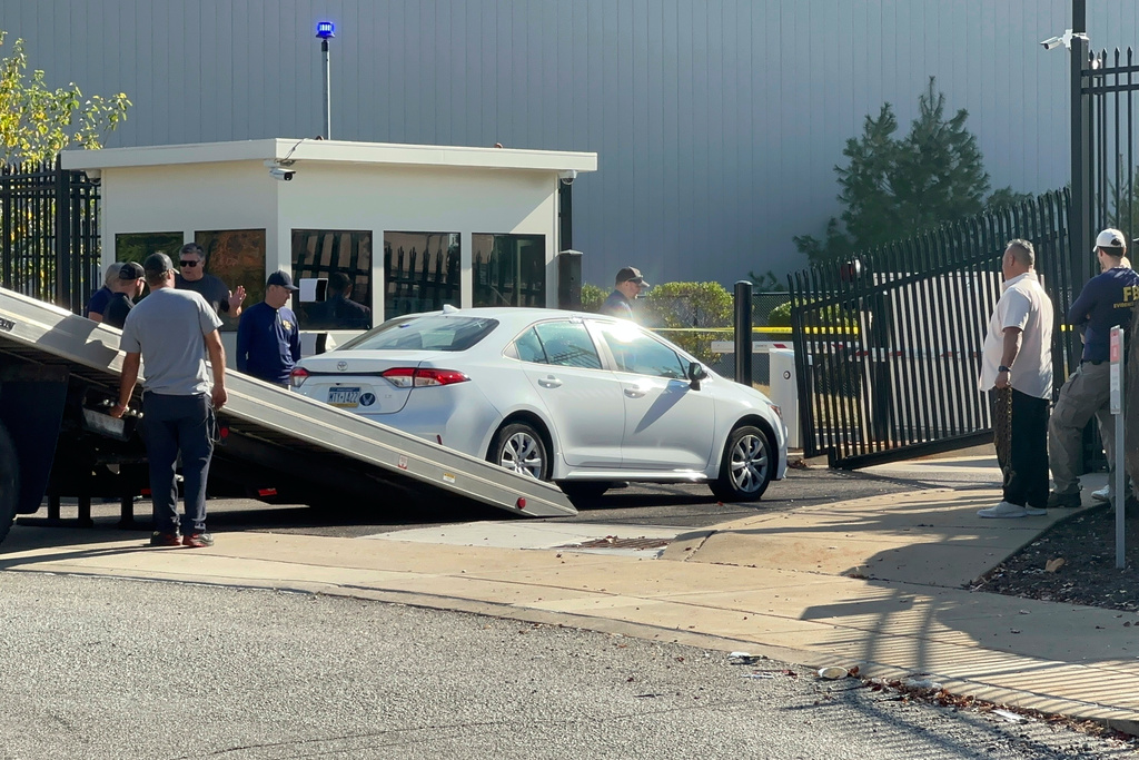 A car that rammed into a gate at the FBI building is removed in Pittsburgh, Wednesday, Sept. 17, 2025. (AP Photo/Peter Smith)