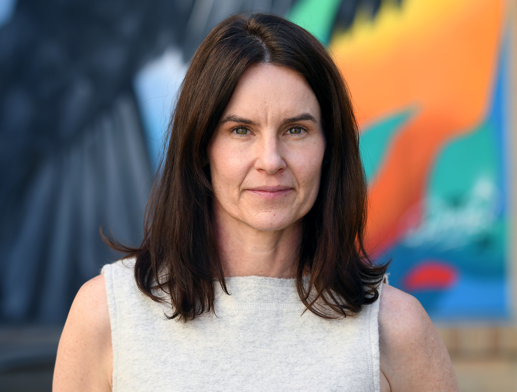 Julie Hoebel, director of development and real estate assets for Grovewood Community Development, poses for a portrait in the courtyard of the Sapling Grove Apartments, an affordable housing complex, in Aurora, Colo., on Friday, March 20, 2026. (AP Photo/Thomas Peipert)