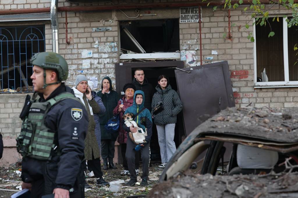Local residents react after a Russian missile hit their hostel in Zaporizhzhia, Ukraine, Thursday, Oct. 30, 2025. (AP Photo/Kateryna Klochko)