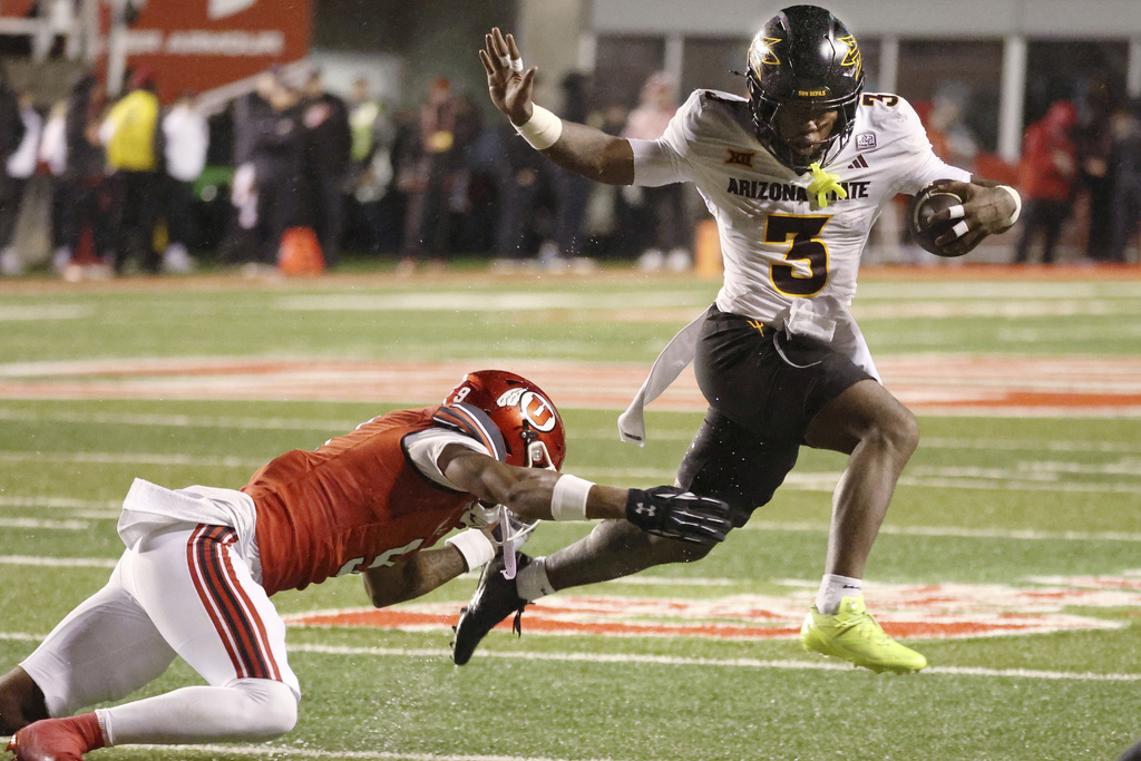 Arizona running back Raleek Brown (3) runs past Utah cornerback Elijah Davis during the first half of an NCAA college football game Saturday, Oct. 11, 2025, in Salt Lake City, Utah. (AP Photo/Jeffrey D. Allred)