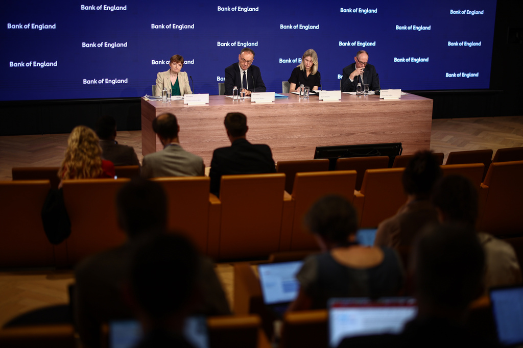 From left: Bank of England (BoE) Deputy Governor Clare Lombardelli, BoE Governor Andrew Bailey, head of media Katie Martin and BoE Deputy Governor for Markets and Banking Dave Ramsden take part in the Monetary Policy Report press conference in London, Thursday, July 30, 2026. (Henry Nicholls/Pool Photo via AP)