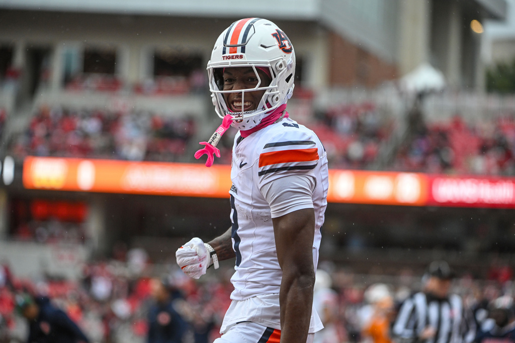 Auburn wide receiver Cam Coleman (8) celebrates after making a touchdown catch against Arkansas during the first half of an NCAA college football game Saturday, Oct. 25, 2025, in Fayetteville, Ark. (AP Photo/Michael Woods)
