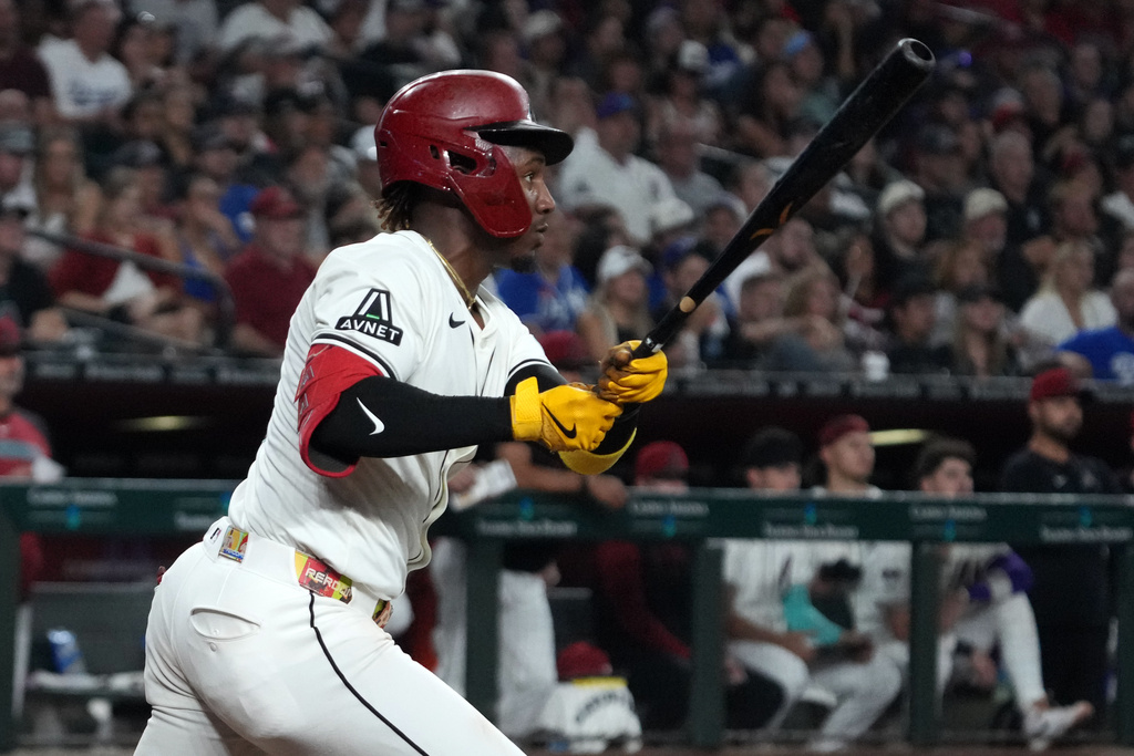 Arizona Diamondbacks' Ketel Marte hits a single against the Los Angeles Dodgers in the fourth inning of a baseball game, Tuesday, Sept. 23, 2025, in Phoenix. (AP Photo/Rick Scuteri)