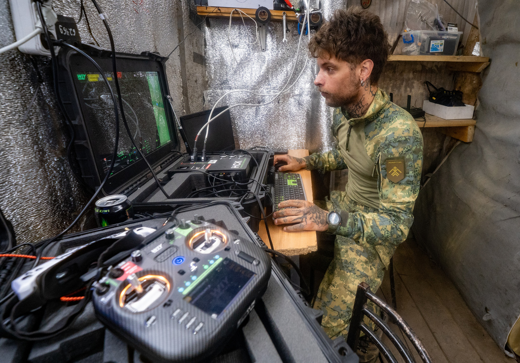 A Ukrainian serviceman of Khartia brigade controls an interceptor drone in the command centre Kharkiv region, Ukraine, Friday, June 26, 2026. (AP Photo/Andrii Marienko)