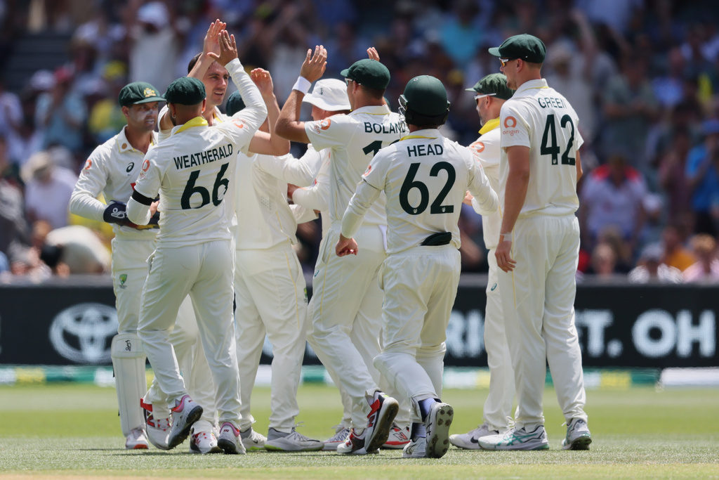 Australia's Pat Cummins is congratulated by teammates after dismissing England's Ben Duckettduring play on day four of the third Ashes cricket test between England and Australia in Adelaide, Australia, Saturday, Dec. 20, 2025. (AP Photo/James Elsby)