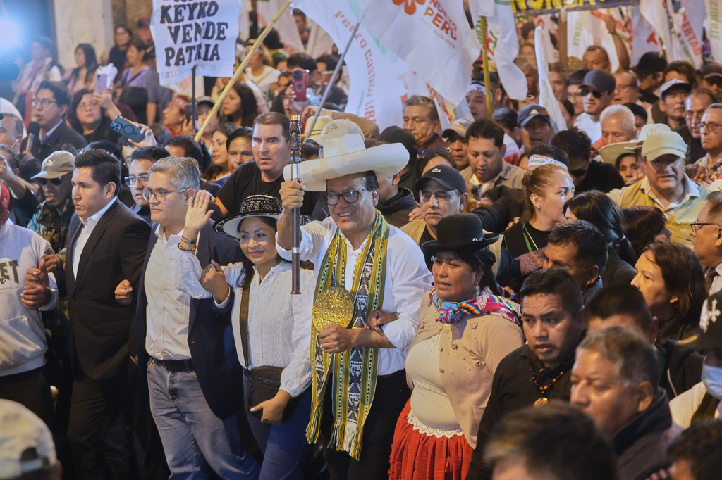FILE - Presidential candidate Roberto Sanchez of the Together for Peru party, center, walks with supporters during a protest against presidential candidate Keiko Fujimori of the Popular Force party in Lima, Peru, June 19, 2026. (AP Photo/Miguel Paredes, File)