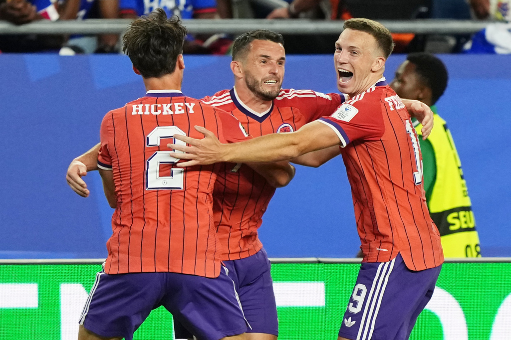 Scotland's John McGinn (7) celebrates with teammate's Aaron Hickey (2) and Lewis Ferguson (19) after scoring his teams first goal during the World Cup Group C soccer match between Haiti and Scotland in Foxborough, Mass., near Boston, Saturday, June 13, 2026. (AP Photo/Martin Meissner)