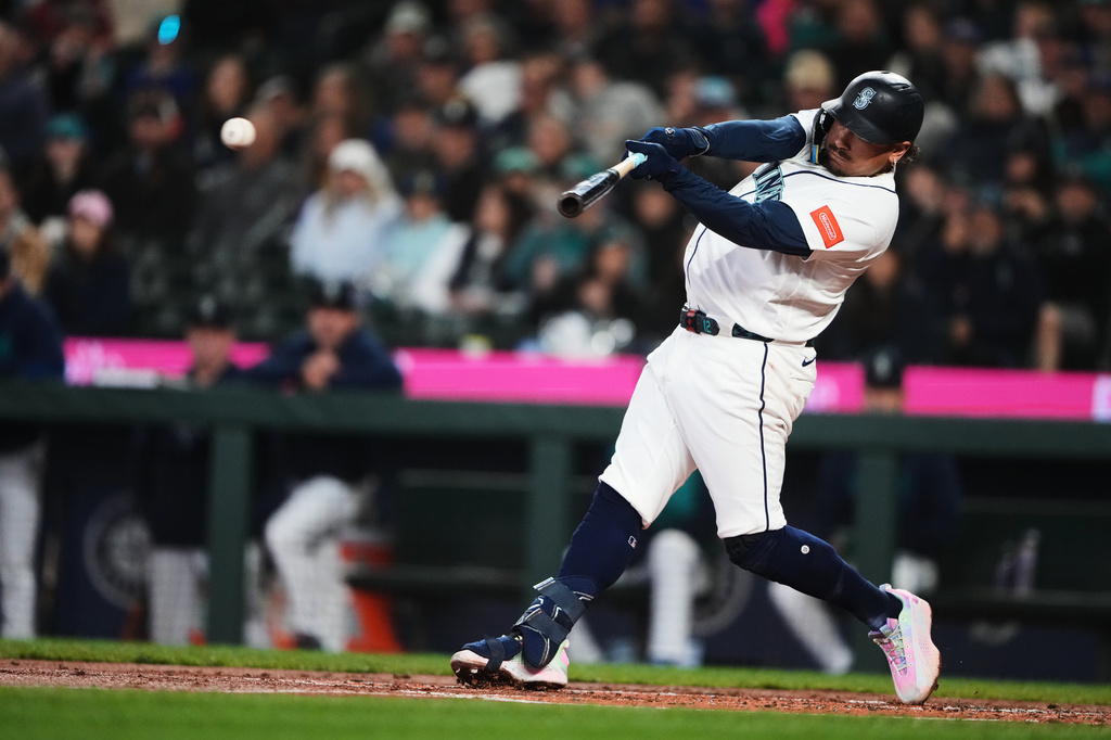 Seattle Mariners' Josh Naylor hits a single against the Athletics during the first inning of a baseball game, Wednesday, April 22, 2026, in Seattle. (AP Photo/Lindsey Wasson)