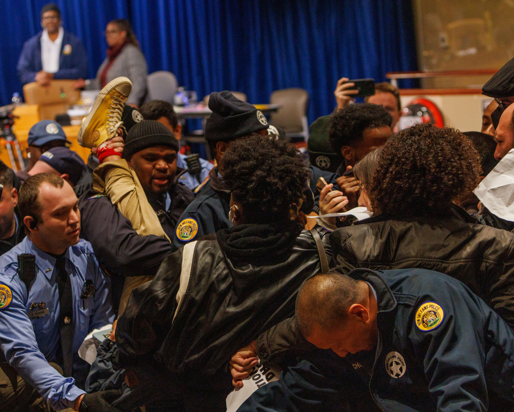 Protesters participate in an anti-ICE demonstration during a meeting at the City Hall in New Orleans, Thursday, Dec. 4, 2025. (Enan Chediak/The Times-Picayune/The New Orleans Advocate via AP)