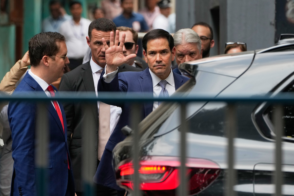 U.S. Secretary of State Marco Rubio, center, waves to the media as he comes out after a visit at Mother House, the headquarters of the Missionaries of Charity in Kolkata, India, Saturday, May 23, 2026. (AP Photo/Bikas Das)