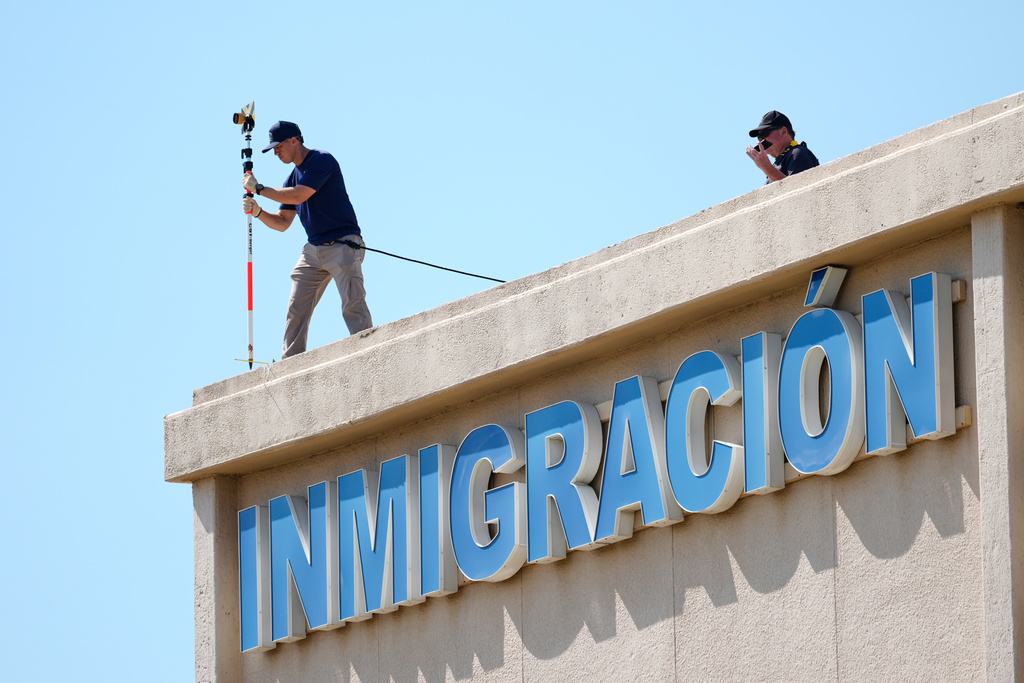 FBI agents investigate the crime scene near a U.S. Immigration and Customs Enforcement office Thursday, Sept. 25, 2025, in Dallas. (AP Photo/Tony Gutierrez)