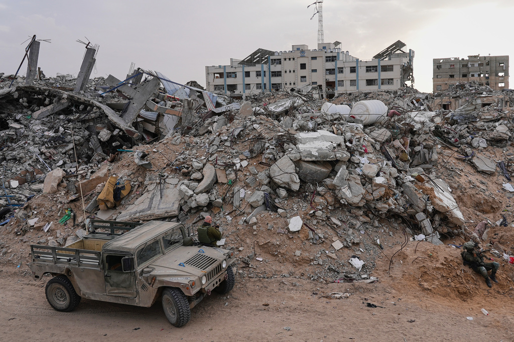 Israeli soldiers gather next to the entrance of a tunnel where the army says the body of soldier Hadar Goldin was held in Rafah, Gaza Strip, Monday, Dec. 8, 2025. Hamas returned his remains to Israel as part of the current ceasefire. (AP Photo/Sam Mednick)