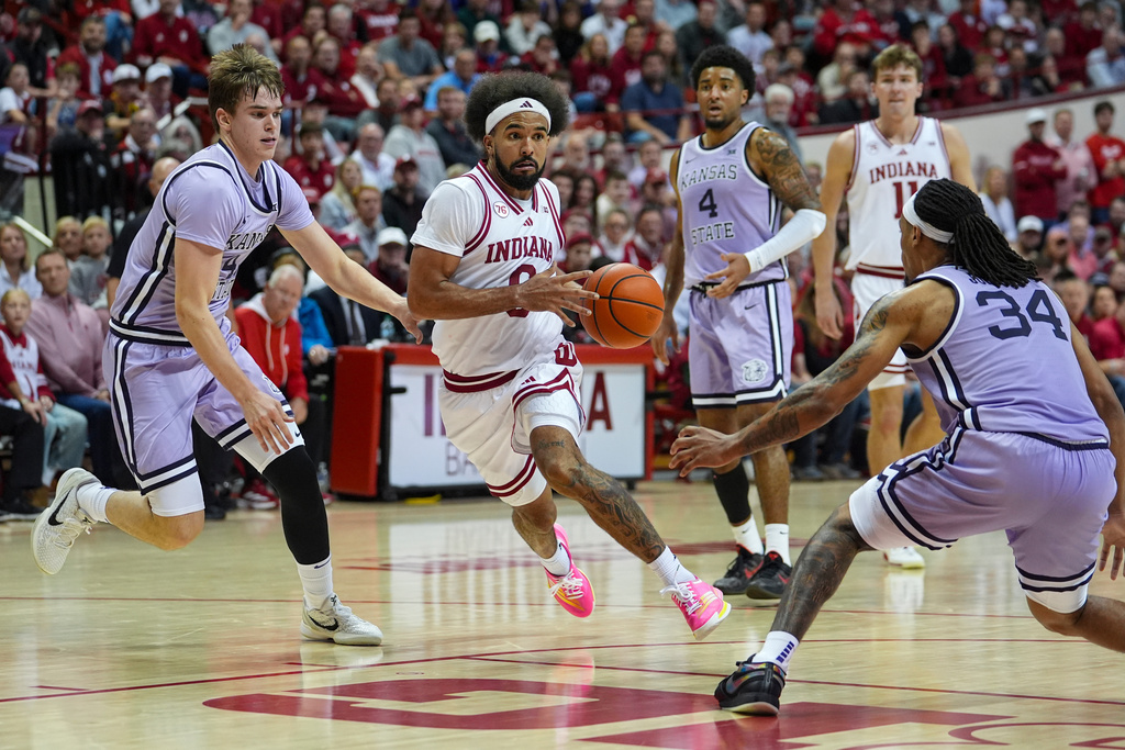 Indiana guard Tayton Conerway (6) drives between Kansas State guard Andrej Kostic (47) and guard Nate Johnson (34) in the second half of an NCAA college basketball game in Bloomington, Ind., Tuesday, Nov. 25, 2025. (AP Photo/Michael Conroy)