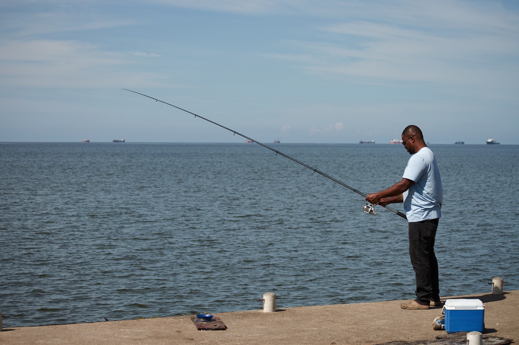 A man fishes in Cocorite, Trinidad and Tobago, Friday, Oct. 3, 2025. (AP Photo/Anselm Gibbs)