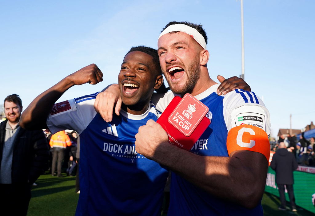 Macclesfield FC goalscorers Paul Dawson, right and Isaac Buckley-Ricketts celebrate following the FA Cup third round soccer match between Macclesfield Town and Crystal Palace, at the Leasing.com Stadium, Macclesfield, England, Saturday, Jan. 10, 2026. (Martin Rickett/PA via AP)