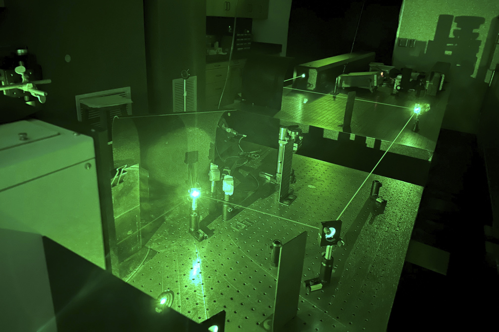 In this photo provided by researchers, lasers are used to determine a chemical fingerprint of samples of the blue paint from the Jackson Pollock painting "Number 1A, 1948" in Stanford, Calif., on Jan. 30, 2023. (Alexander Heyer via AP)