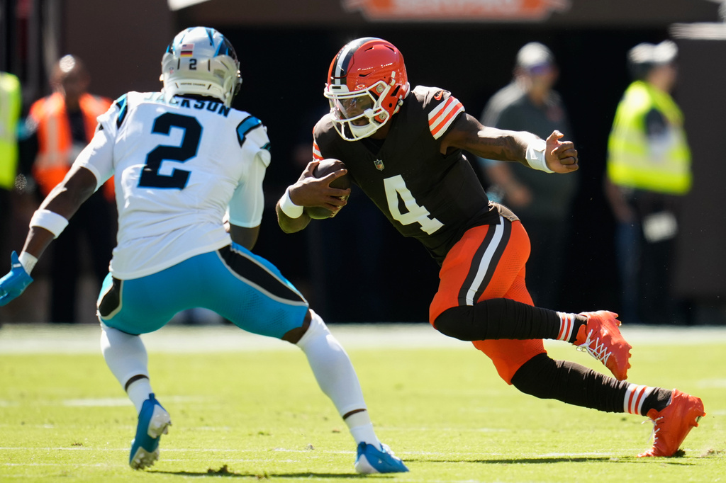 Cleveland Browns quarterback Deshaun Watson (4) runs with the ball against Carolina Panthers cornerback Mike Jackson (2) during the first half of an NFL football game in Cleveland, Thursday, Aug. 27, 2026. (AP Photo/Sue Ogrocki)