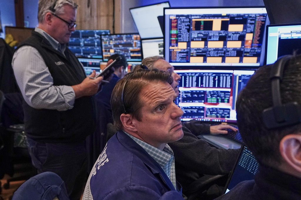 Trader Michael Milano, center, works on the floor of the New York Stock Exchange, Friday, June 26, 2026. (AP Photo/Richard Drew)