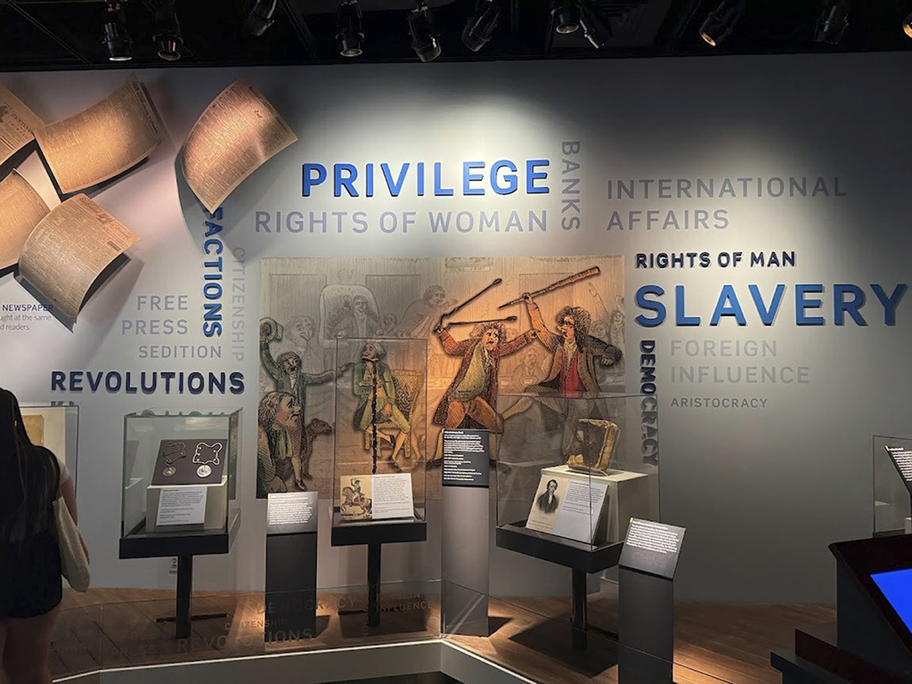 This wall in the “Great Debate” section of a democracy exhibit at the National Museum of American History, shown Aug. 26, 2025, in Washington, reflects some of the issues the nation grapples with. President Donald Trump is pressing for changes in the stories the Smithsonian museums tell about America. He wants U.S. history cast in a more positive light. (AP Photo/Calvin Woodward)