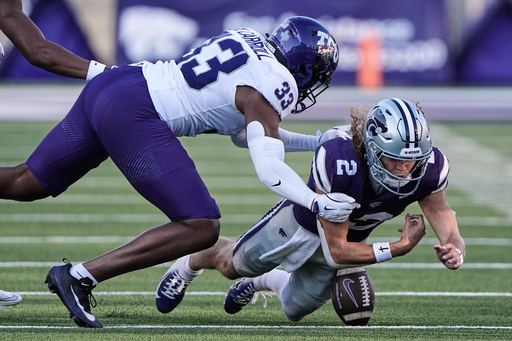 Kansas State quarterback Avery Johnson (2) recovers his own fumble for a first down as he is tackled by TCU linebacker Max Carroll (33) during the second half of an NCAA college football game Saturday, Oct. 11, 2025, in Manhattan, Kan. (AP Photo/Charlie Riedel) Kansas State quarterback Avery Johnson (2) recovers his own fumble for a first down as he is tackled by TCU linebacker Max Carroll (33) during the second half of an NCAA college football game Saturday, Oct. 11, 2025, in Manhattan, Kan. (AP Photo/Charlie Riedel)