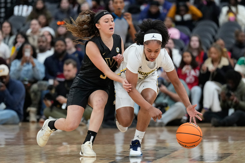Vanderbilt's Aubrey Galvan, left, and Michigan's Mila Holloway compete for the ball during the first half of an NCAA women's college basketball game in Newark, N.J., Monday, Jan. 19, 2026. (AP Photo/Seth Wenig)