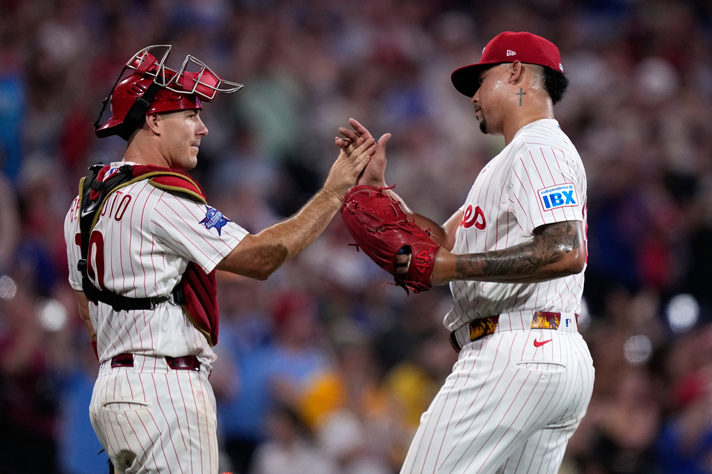 Philadelphia Phillies' J.T. Realmuto, left, and Jhoan Duran celebrate after the Phillies won a baseball game against the Pittsburgh Pirates Wednesday, July 1, 2026, in Philadelphia. (AP Photo/Matt Slocum)